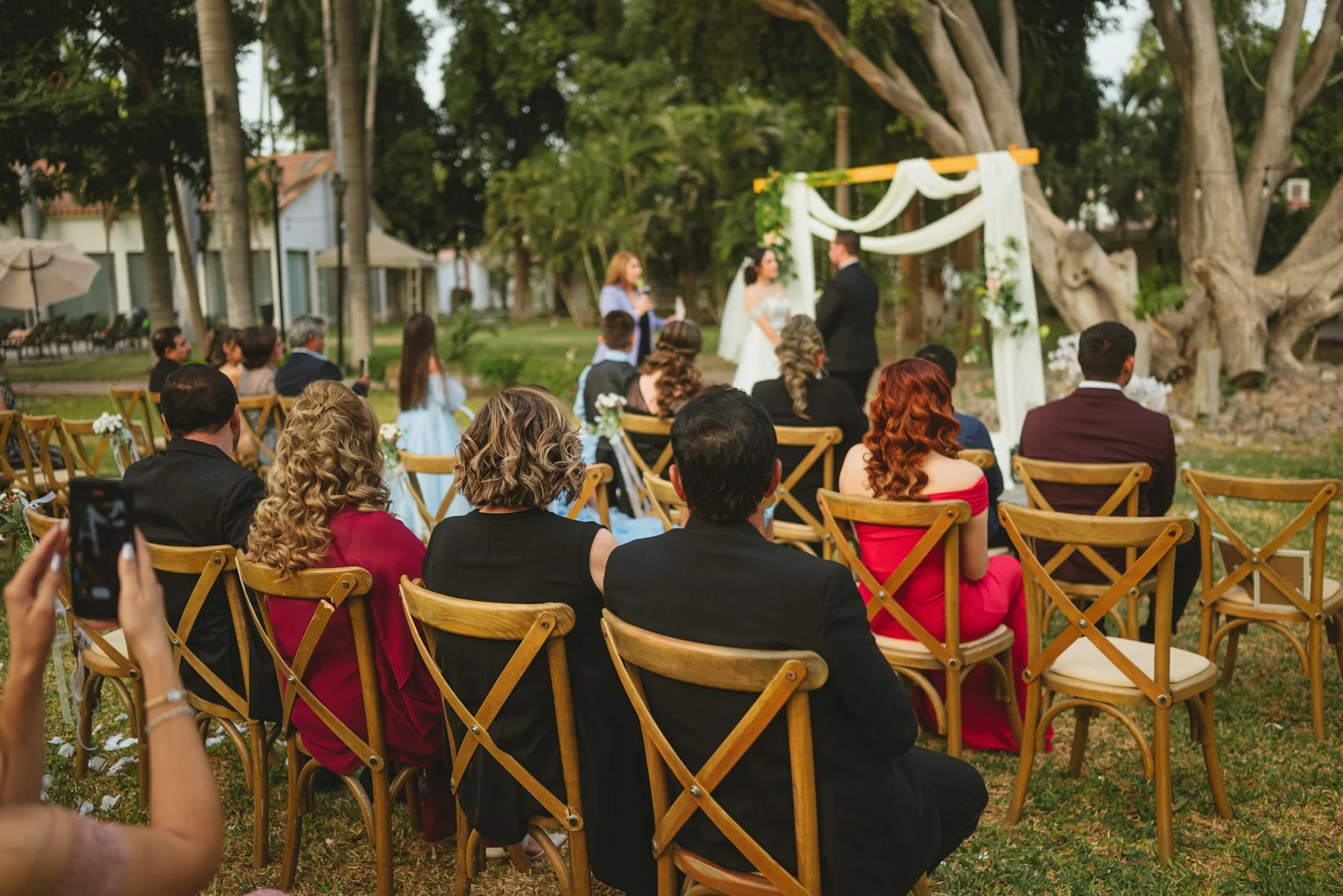A relaxed wedding rehearsal walk-through with the couple and their wedding party in a Canterbury garden